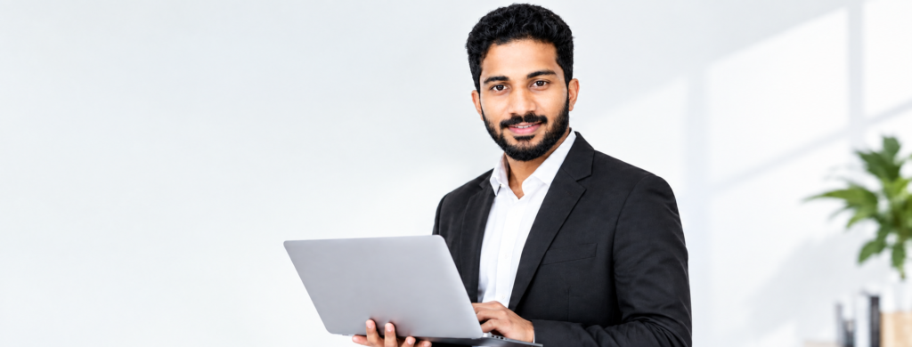 Professional Man Using Laptop In Bright Office 1024x390